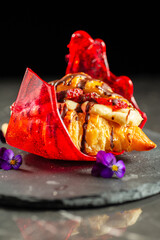 Mouth-watering croissant filled with fresh strawberries and pastry cream drizzled in milk chocolate.