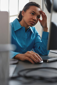 Stressed computer programmer working on desktop PC