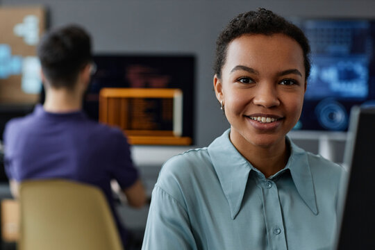 Happy young IT professional in office