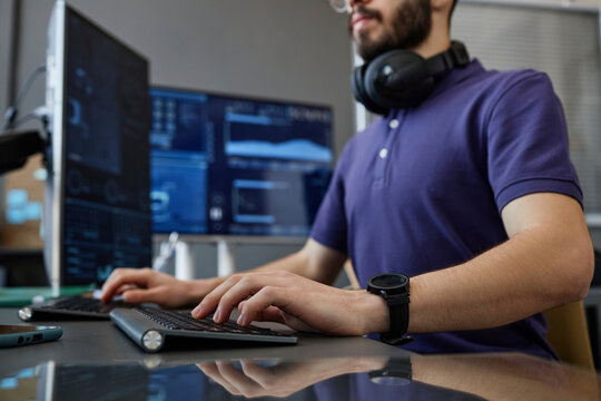 IT professional typing on computer keyboard at desk