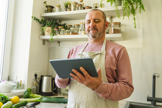 Senior man using tablet PC at home
