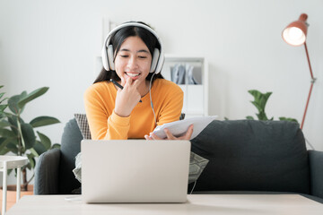 Asian girl work using laptop, online learn video conference with headphones - 637247880