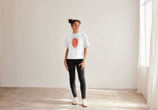 Mockup of woman wearing t-shirt with customizable color, standing full length