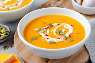 Pumpkin Soup, Tasty Homemade Pumpkin, Sweet Potato, Carrot Soup in a Bowl on Bright Background