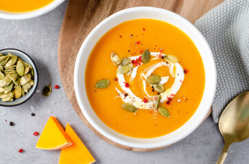 Pumpkin Soup, Tasty Homemade Pumpkin, Sweet Potato, Carrot Soup in a Bowl on Bright Background