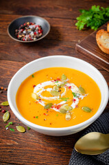 Pumpkin Soup, Tasty Homemade Pumpkin, Sweet Potato, Carrot Soup in a Bowl on Dark Background