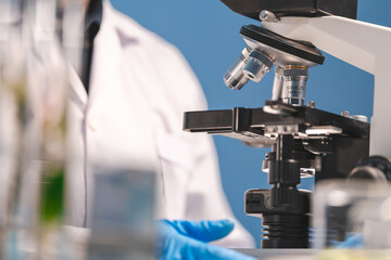 professional chemist woman laboratory using scientific microscope for science research, chemistry scientist with microbiology medicals equipment technology to working with medicine biology experiment