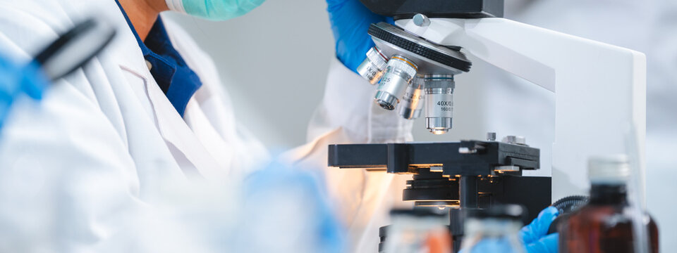 professional chemist woman laboratory using scientific microscope for science research, chemistry scientist with microbiology medicals equipment technology to working with medicine biology experiment