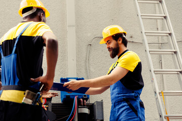 Precise servicemen repairing and maintaining heating, ventilation, and air conditioning systems....