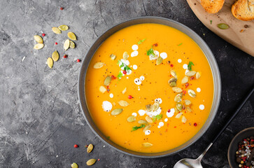 Pumpkin Soup, Tasty Homemade Pumpkin, Sweet Potato, Carrot Soup in a Bowl on Dark Background