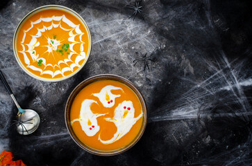 Obraz na płótnie Canvas Pumpkin Soup, Halloween Cream Soup on Dark Cobweb Background
