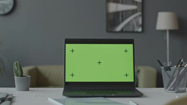 No people shot of laptop with chroma key green screen at workplace in contemporary office