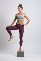 Obraz premium Core balance exercise: Sportswoman doing a one leg stand workout