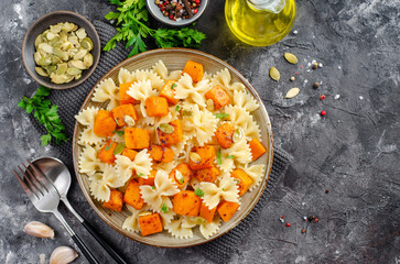 Pasta with Roasted Pumpkin, Farfalle Pasta with Pumpkin on a Plate on Dark Background
