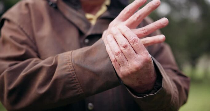 Person, hands and pain with arthritis and health, muscle or joint ache, massage and tension while outdoor. Retirement, pension and medical emergency, inflammation and .tendinitis with old age