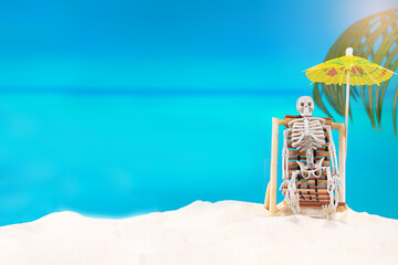 Skeleton on sunbed with umbrella enjoys beach day at sea. Halloween in hot country, burned out....