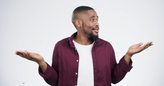 Shrug, hands and face of black man confused in studio with choice, why and dont know gesture on white background. Questions, portrait and African model with palm emoji for thinking, ask or decision