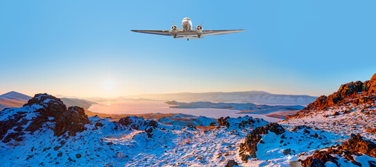 Propoller airplane flying over Baikal lake in winter - Beautiful winter landscape of frozen Baikal...