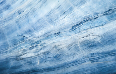 Blue and white textured background close up. Abstract, soft and dreamy background with paint and marble texture. Lines and wrinkles create depth and movement.