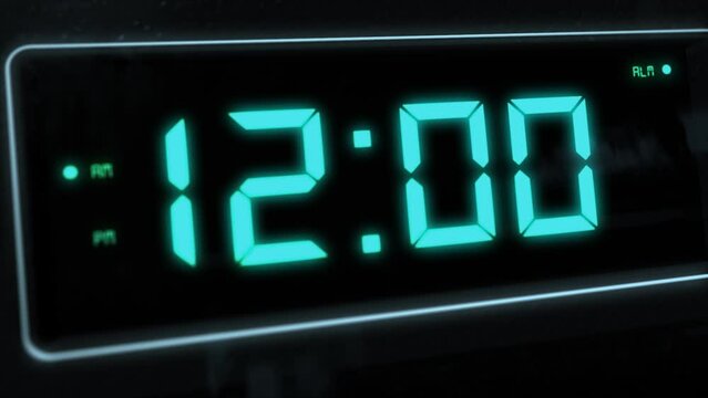 High quality CGI render of a digital alarm clock, with glowing pale blue numbers, ticking over from 11.59 to 12.00 a.m. with rapid left to right camera move - witching hour