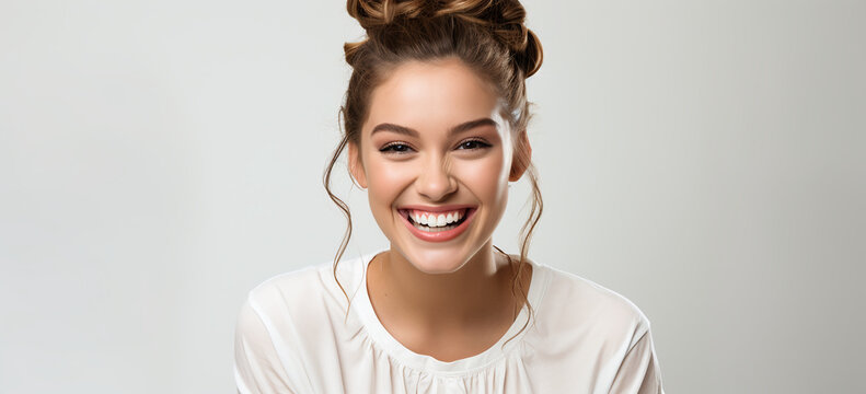 portrait of a young lady smiling on flat white color background. Sensation and emotion concept.