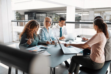 Diverse businesspeople having a meeting together around a table