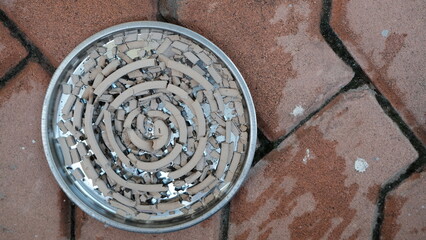 Circle-shaped mosquito repellent ashes laying on the tray.