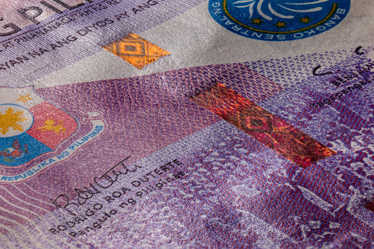 Extreme macro photography of a 100 Peso banknote. Ultra close up of a one hundred filipino peso note. Legal Tender for private and public of the island state of the Philippines. Microscopic capture