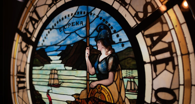 Seal of the State of California, a design in the public domain. The seal shows Athena looking out over sailing ships.