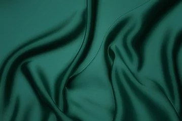 Poster Texture, background, pattern. Texture of green silk fabric. Beautiful emerald green soft silk fabric. © KAL'VAN