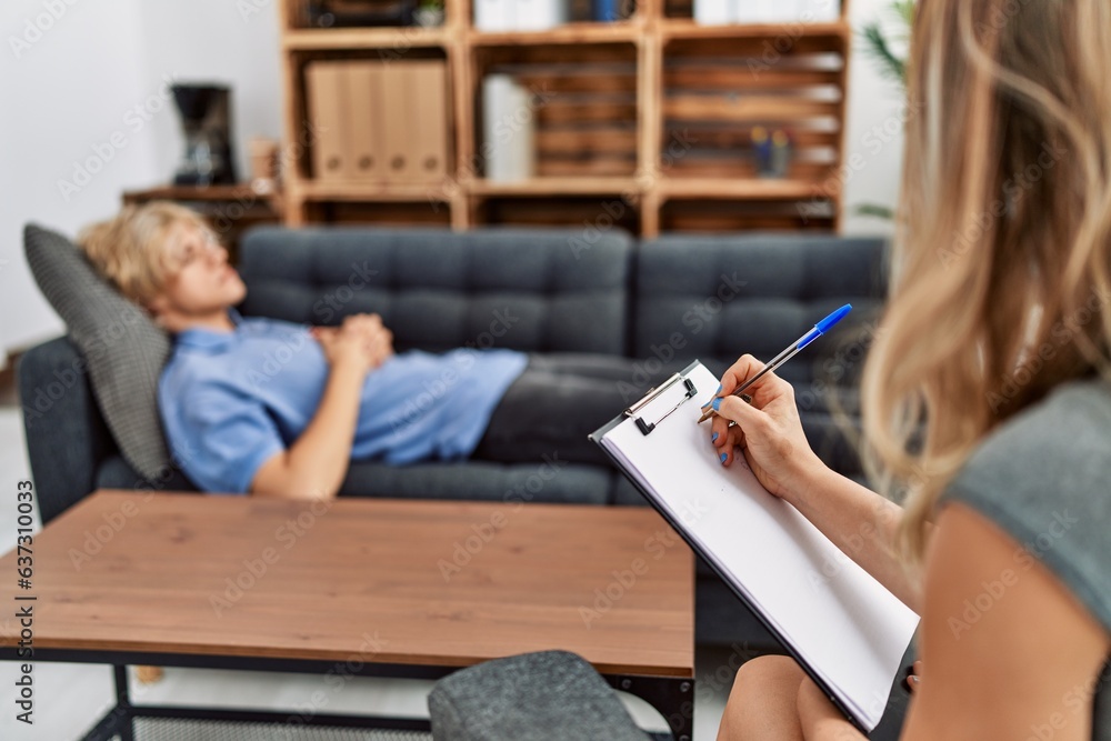 Sticker Young blond man patient having mental therapy lying on sofa at psychology clinic