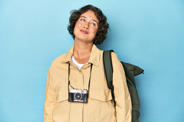 Young traveler woman with vintage camera dreaming of achieving goals and purposes