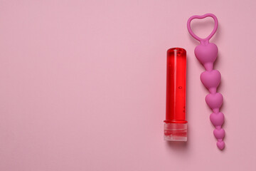 Lubricant with anal balls on a pink background, place for text