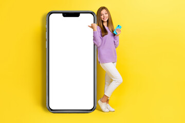 Full length photo of charming lady finger point big device menu screen display offer use modern gadget isolated on yellow color background