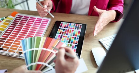 Interior designers work as team with color sample plans on office desk. Choosing the best home renovation paint