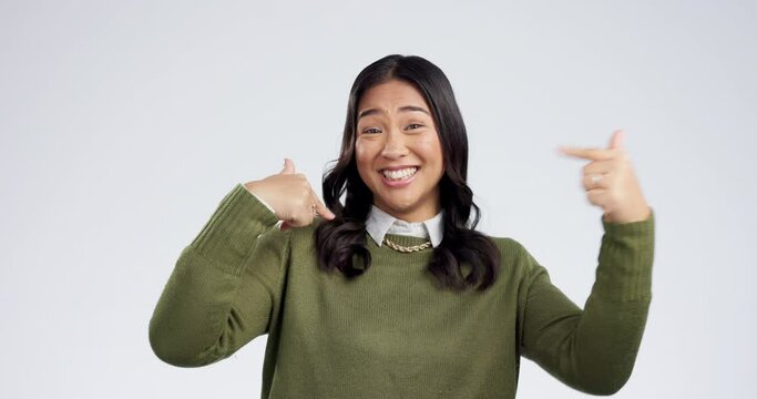 Woman face, pointing finger and choose me with a smile and proud from motivation. Studio, white background and portrait with confidence and myself and decision hand gesture of happy female person