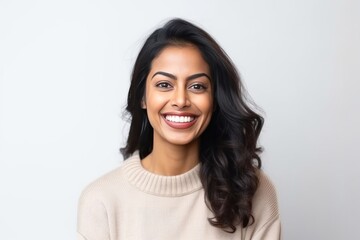 Fototapeta premium Medium shot portrait of an Indian woman in her 30s against a white background