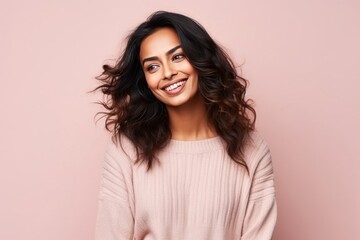 Fototapeta premium Medium shot portrait of an Indian woman in her 30s in a colorful background