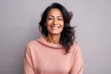 Medium shot portrait of an Indian woman in her 40s in a colorful background