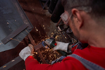 Man cutting metal plank on railing