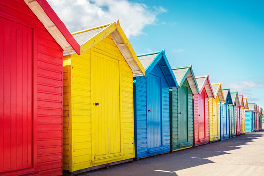 Beach huts or bathing houses on the beach with blue sky background