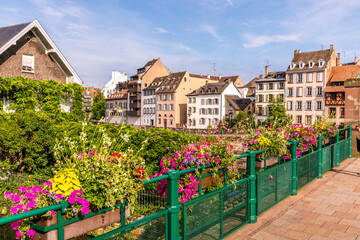 Fototapeta na wymiar Strasbourg, France - June 19, 2023: Traditional half-timbered houses on the picturesque canals of La Petite France in the medieval town of Strasbourg, UNESCO World Heritage Site, Alsace, France