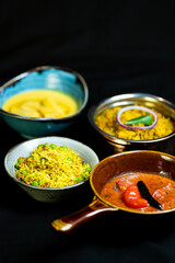 Delicious and colorful Indian food on a black background