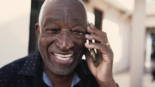 Joyful African American Senior Speaking On Phone Smiling, Close-up Face A Black Elderly Person