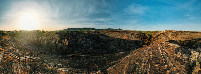 Aerial panoramic view looking north of barren landscape in Cascais, Portugal following forest fires...
