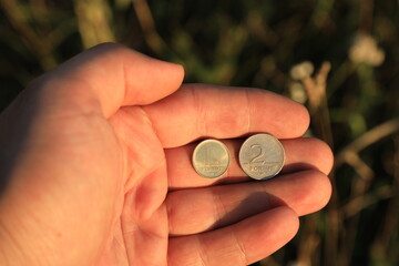 Coins one and two forint in hand