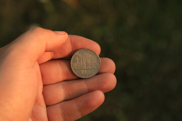 Vintage coin three lei in hand