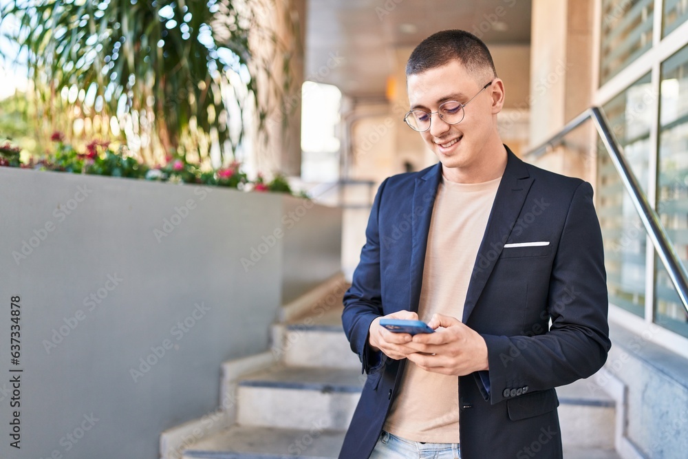 Sticker young hispanic man executive smiling confident using smartphone at street