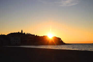 Silhouette of town Primosten, Croatia, illuminated by beautiful sunset light.