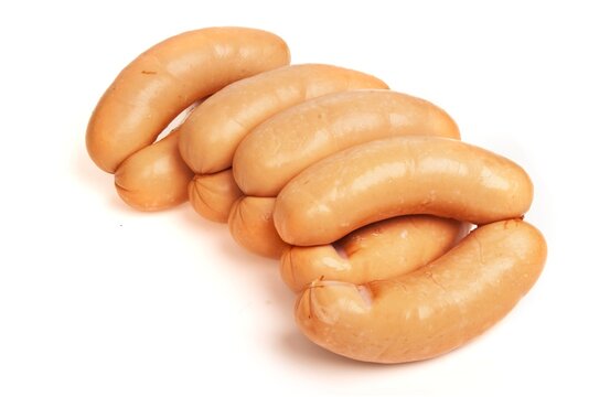 Rings of wiener sausage, isolated on a white background. Traditional Polish meat sausage, parowkowa, packshot photo.